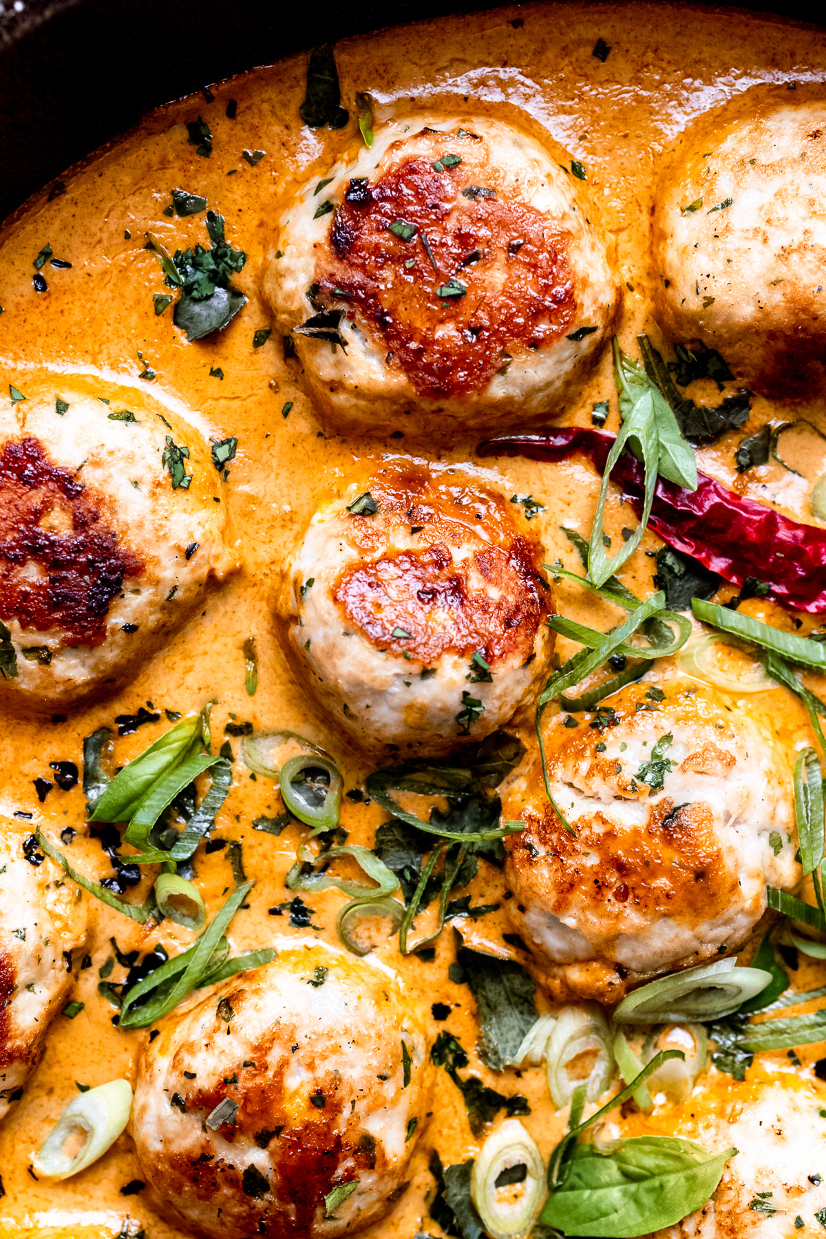 Close up of turkey meatballs in a pan.