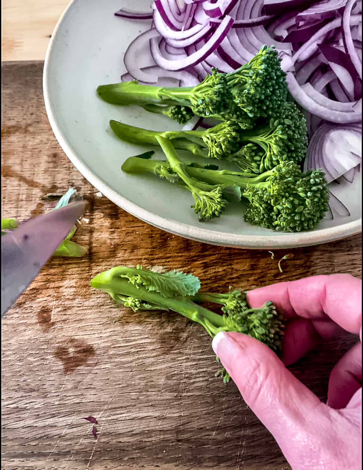 Broccoli being trimmed.