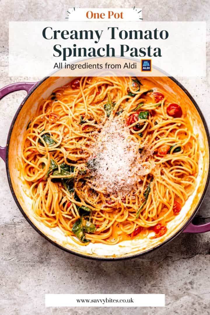 tomato spinach pasta in a pan with text overlay.