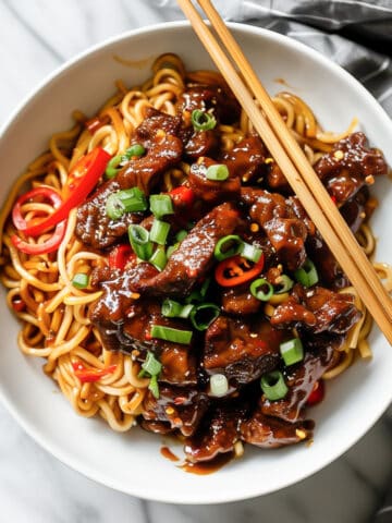 Crispy chili beef with Asian sauce and noodles.
