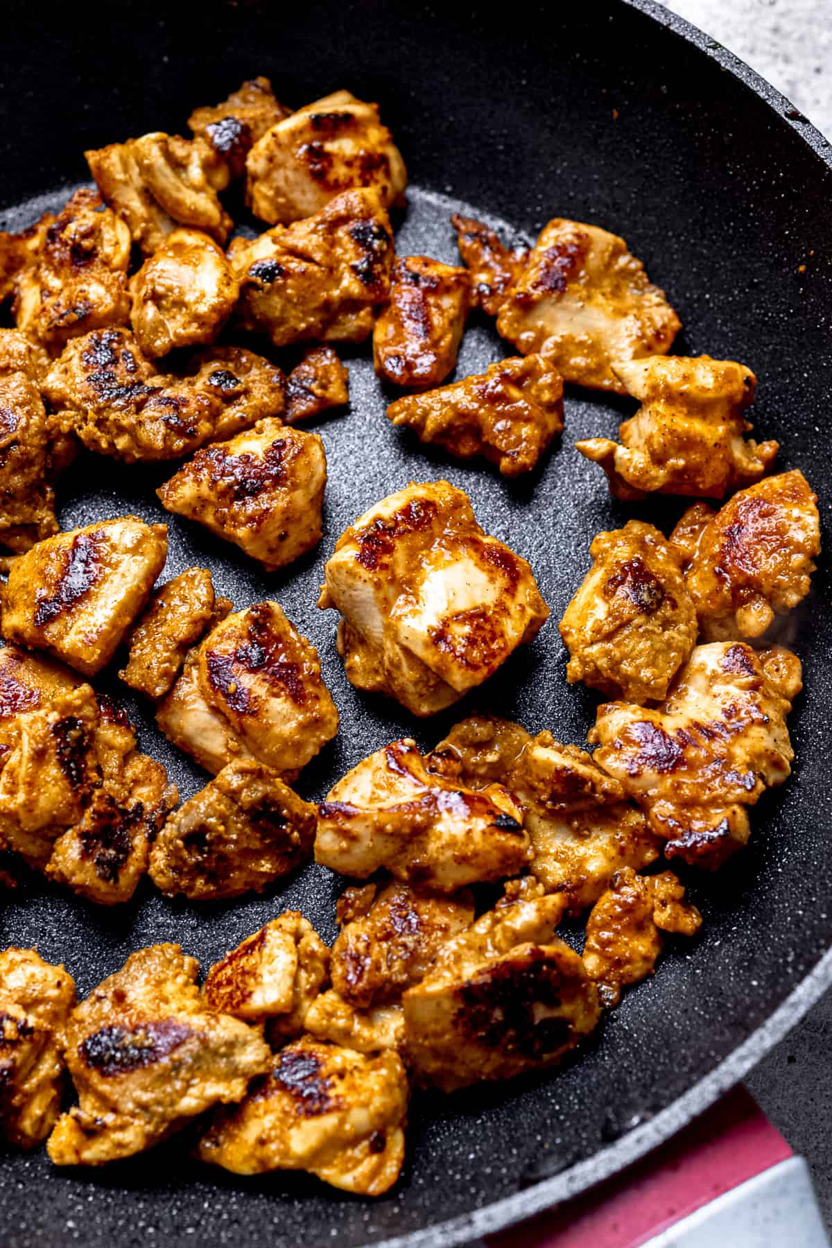 Seared chicken in a pan.