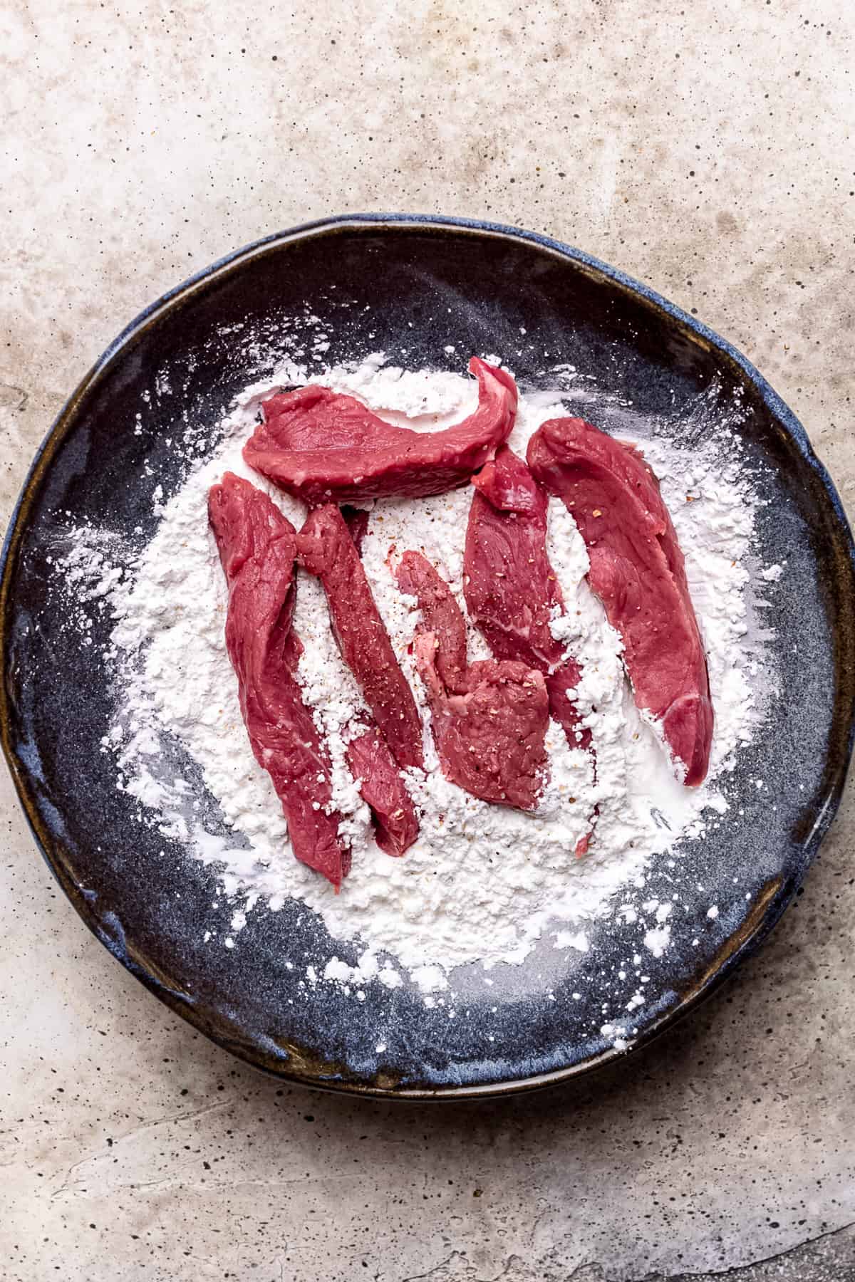 Beef strips in cornflour with salt and pepper.