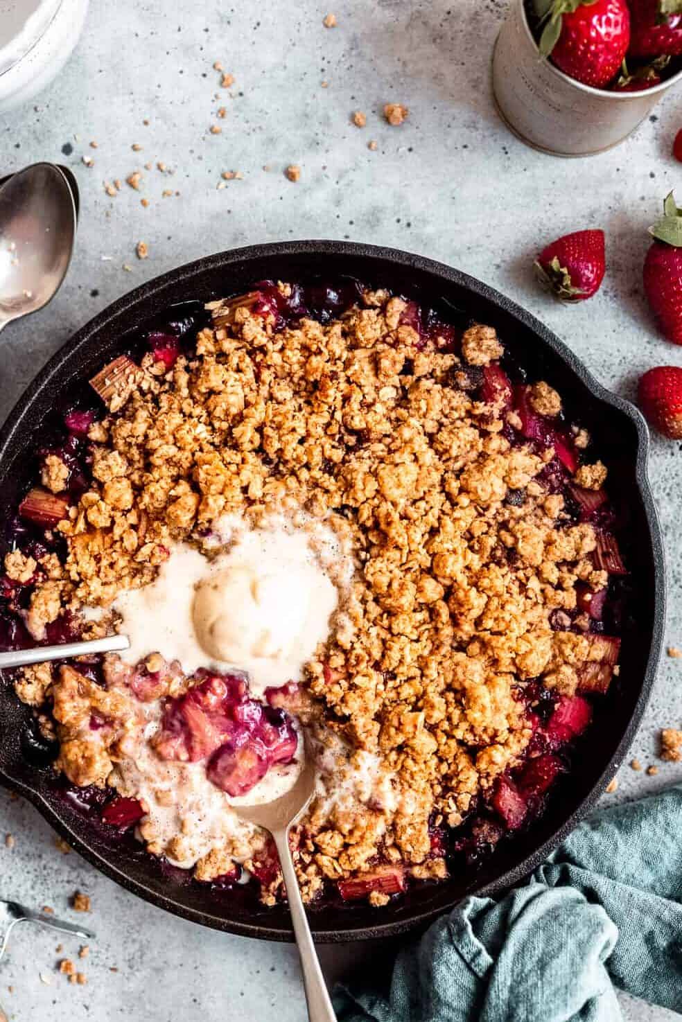 Rhubarb crumble with ice cream and spoons.