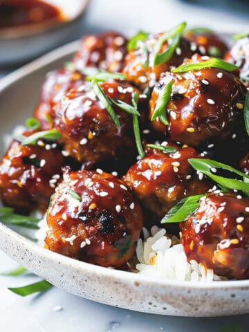 Sticky asian pork meatballs on a bed of rice.