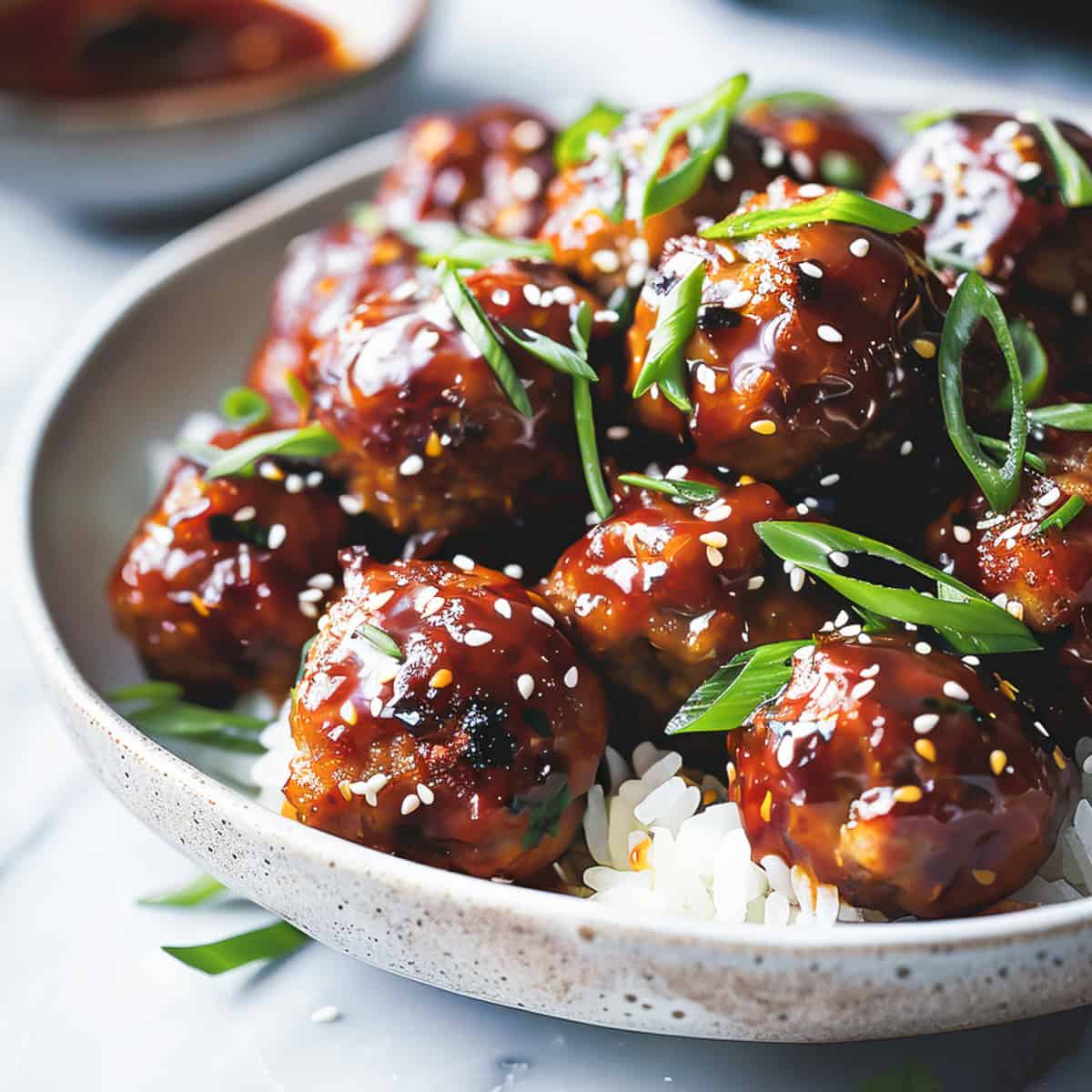 Sticky asian pork meatballs on a bed of rice.