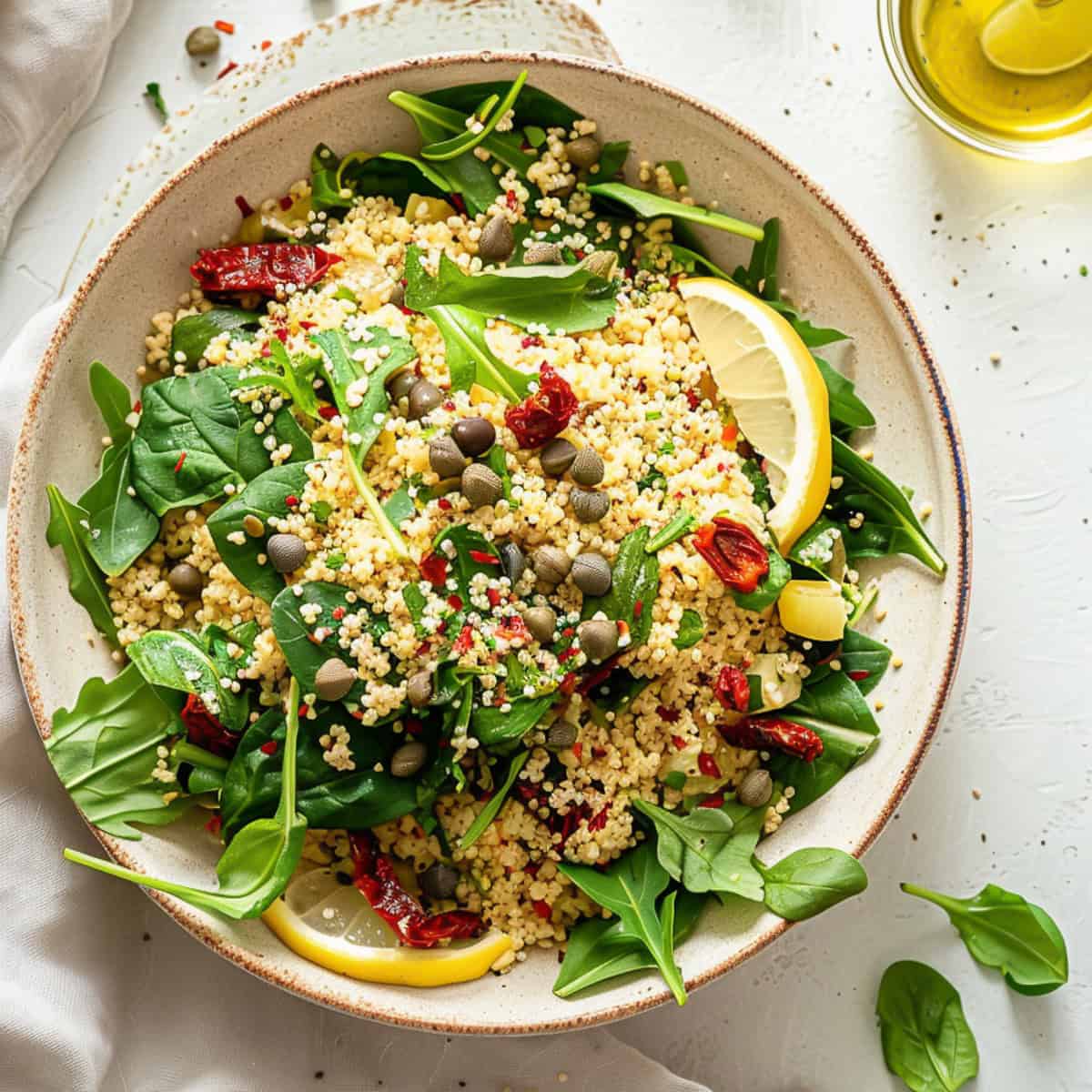 Couscous salad with Moroccan spices and spinach in a bowl.