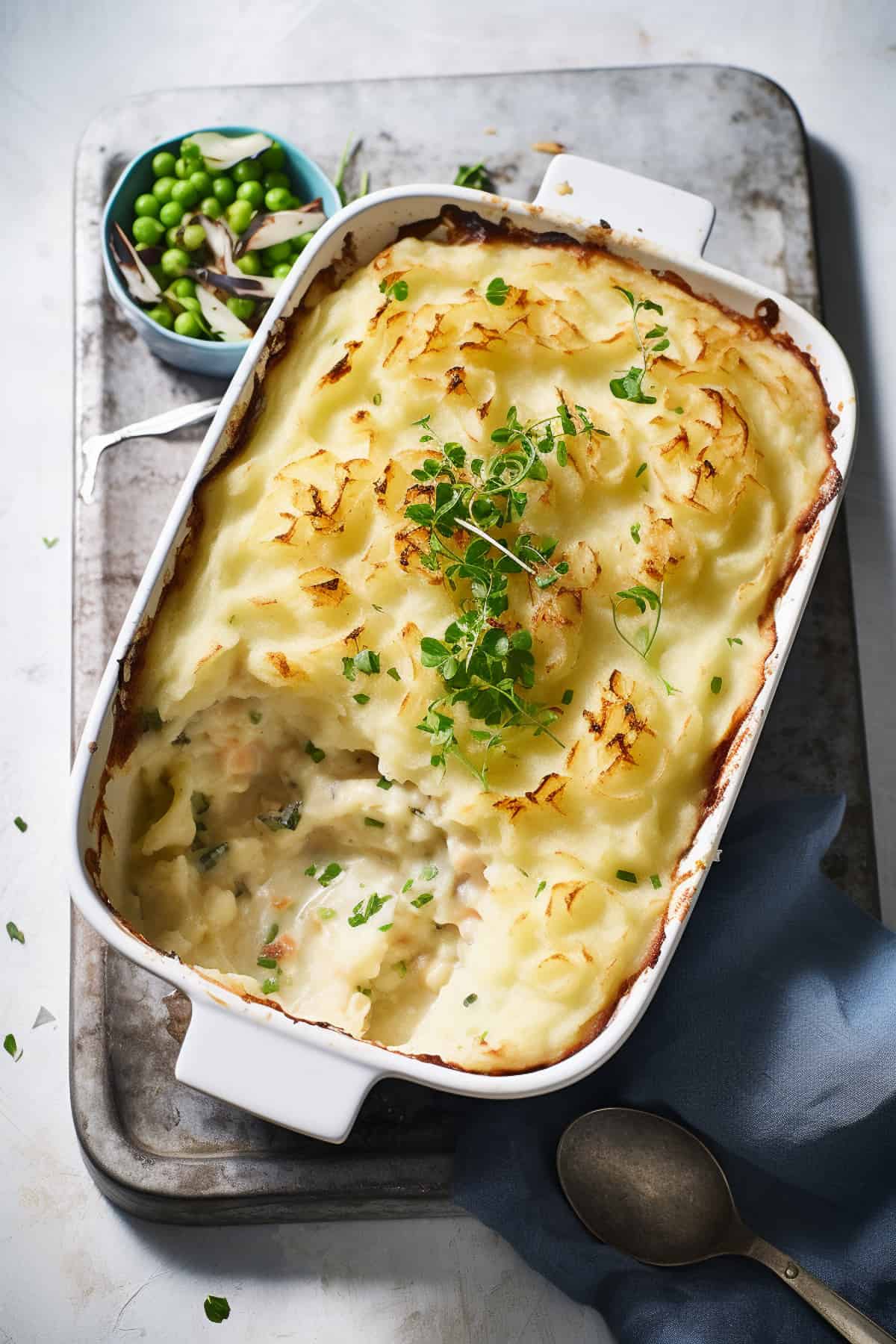 Fish pie in a baking dish with mashed potato topping.