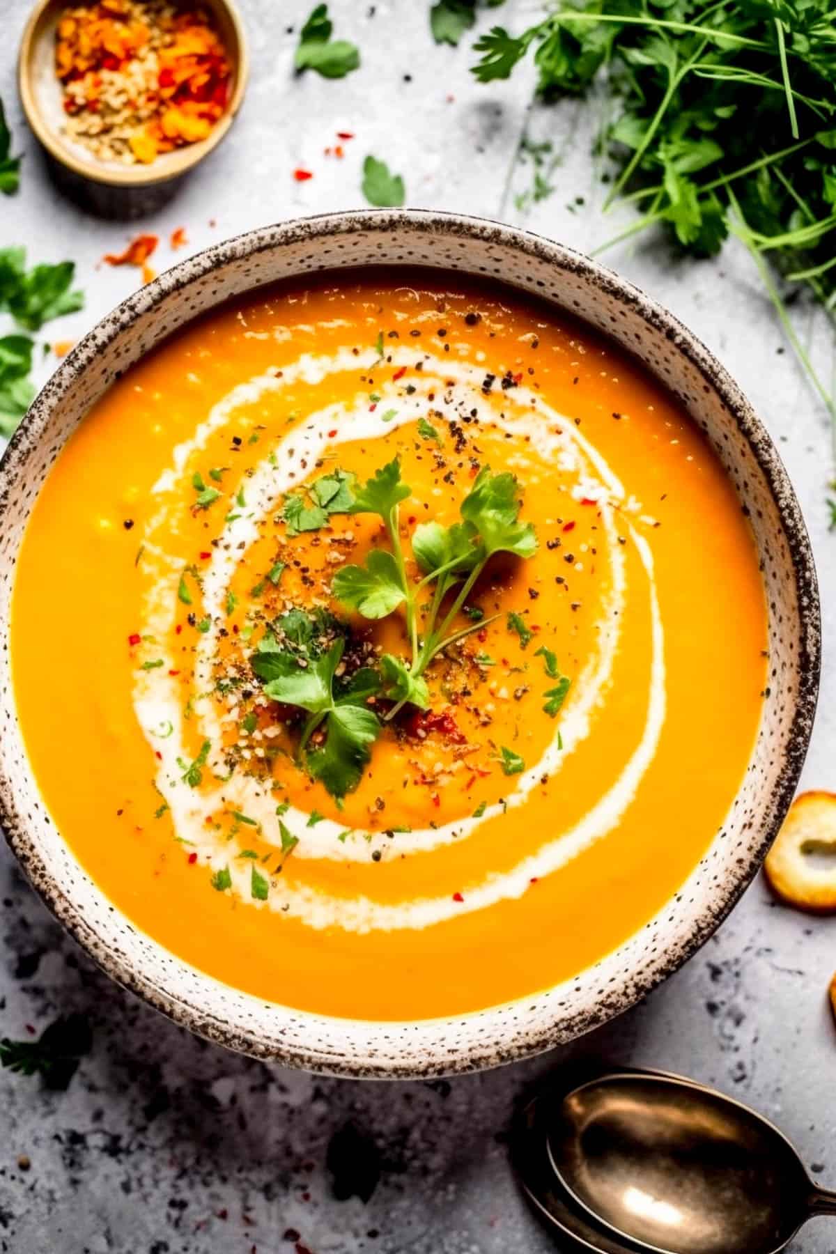 Carrot and coriander soup with fresh coriander on top.