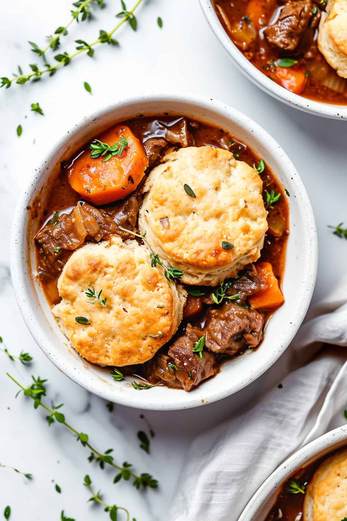 Beef cobbler with cheddar biscuits- slow cooker beef in a bowl.