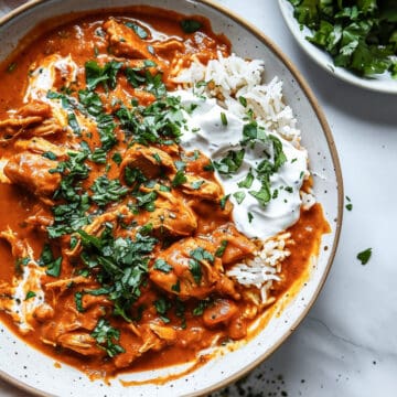 Creamy coconut chicken curry with chopped coriander and rice.