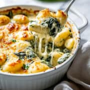 Spinach and artichoke gnocchi baked with cheese and pesto.