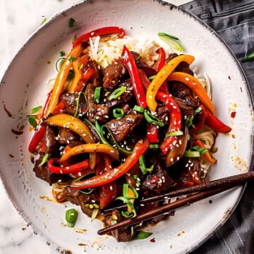 Beef stir fry with peppers over rice.