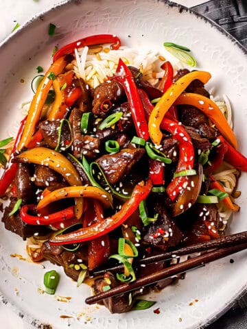 Beef stir fry with peppers over rice.