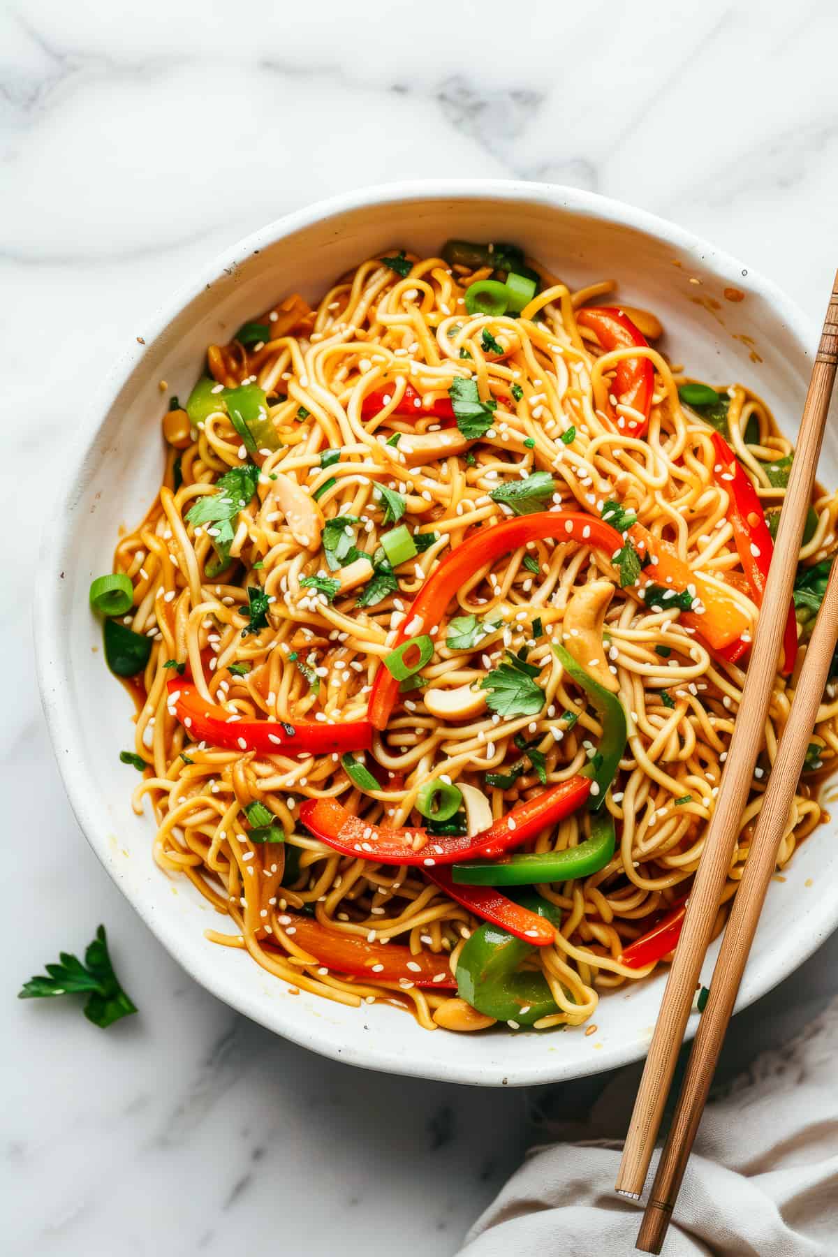 Easy 15-minute Asian-style noodles with vegetables in a white bowl.