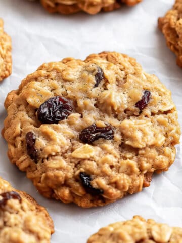 Soft and chewy oat and raisin cookies on baking paper.