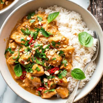 Peanut butter chicken with herbs and chillies over a bed of white rice.