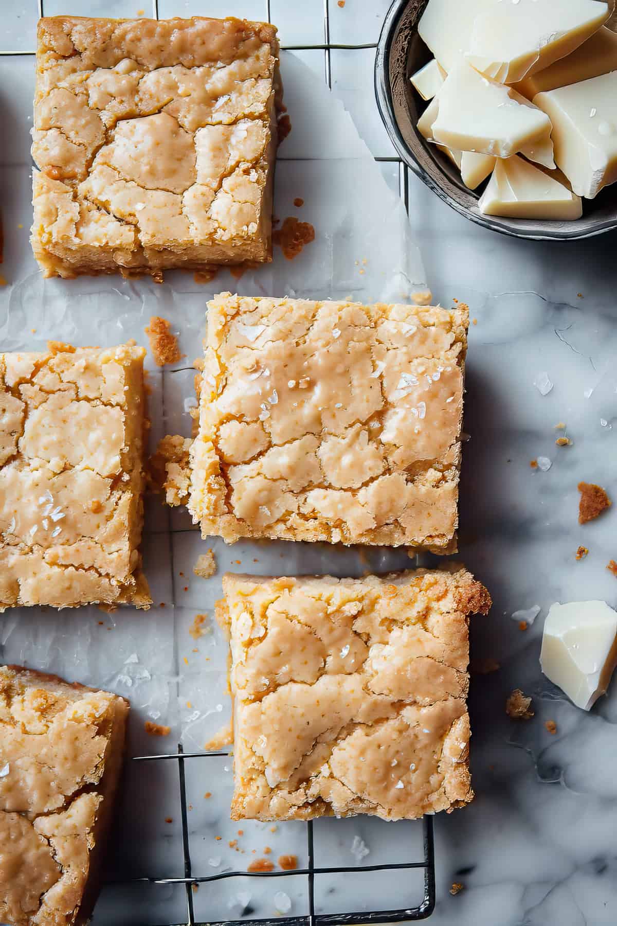 Fudgy white chocolate blondies on a cooling rack.