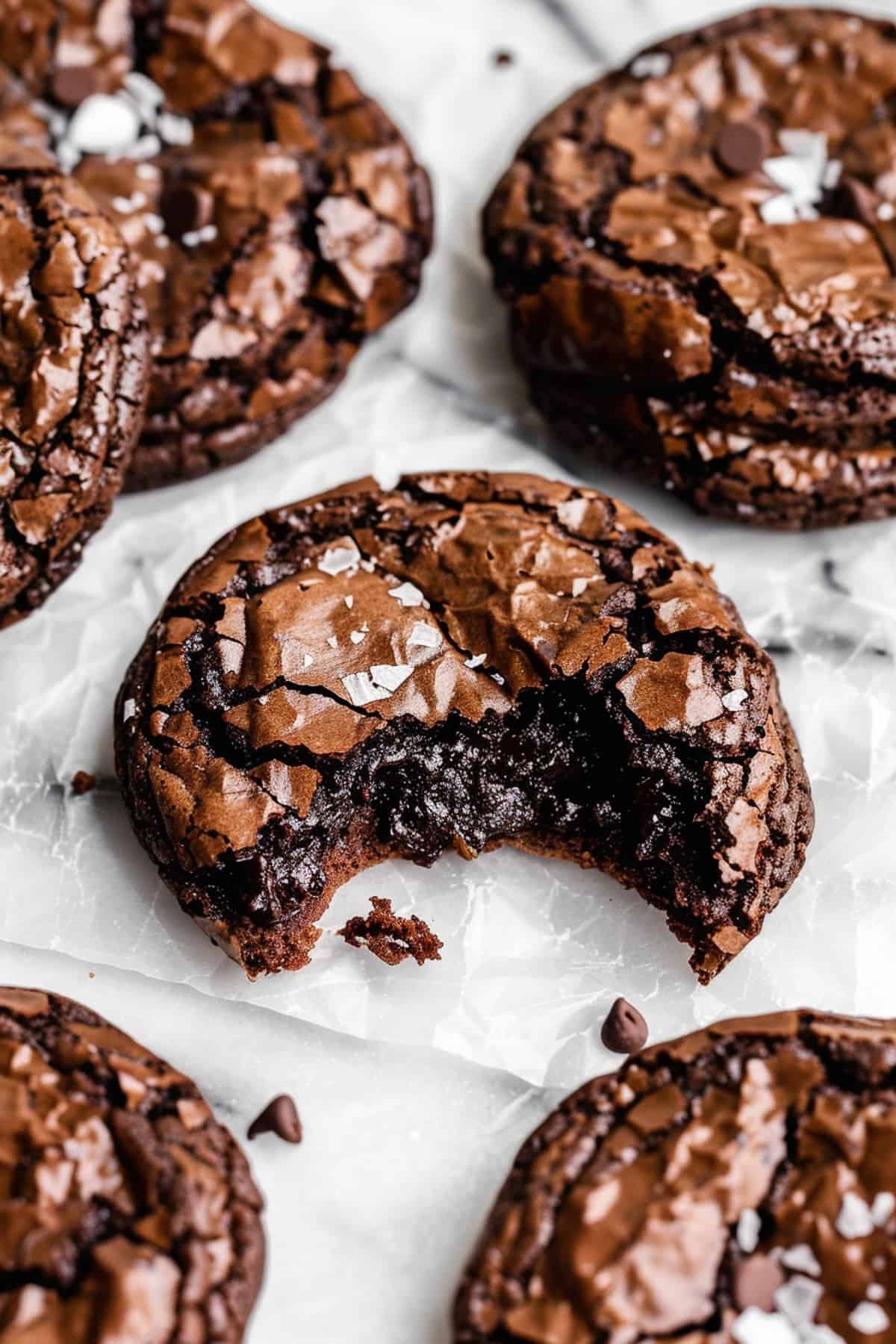Soft and chewy brookies (brownie cookies) on a piece of parchment paper.