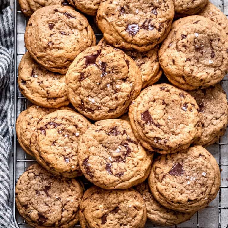 Chocolate chip cookies on a wire cooling rack.