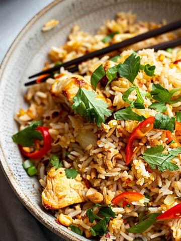 Nasi goreng Indonesian fried rice with herbs and chicken.