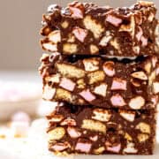 Rocky road bars on a white marble table with marshmallows.