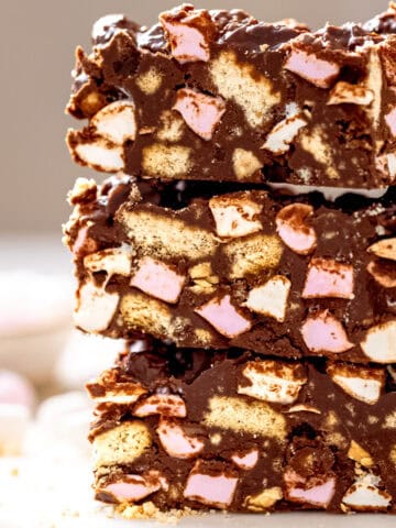 Rocky road bars on a white marble table with marshmallows.