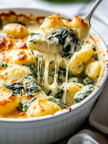 Broccoli and cheese pasta bake in a white casserole dish.