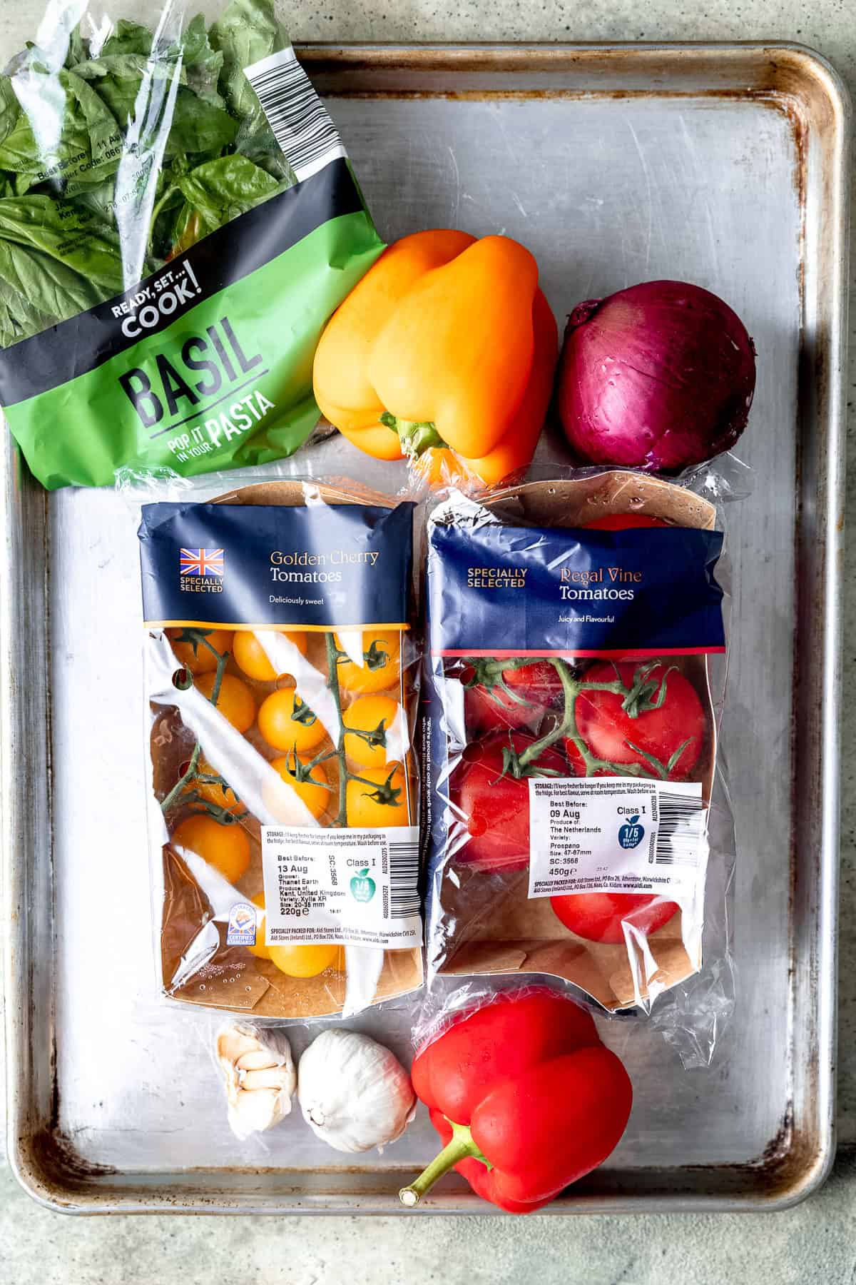 Ingredients for roasted tomato soup on a roasting tray.