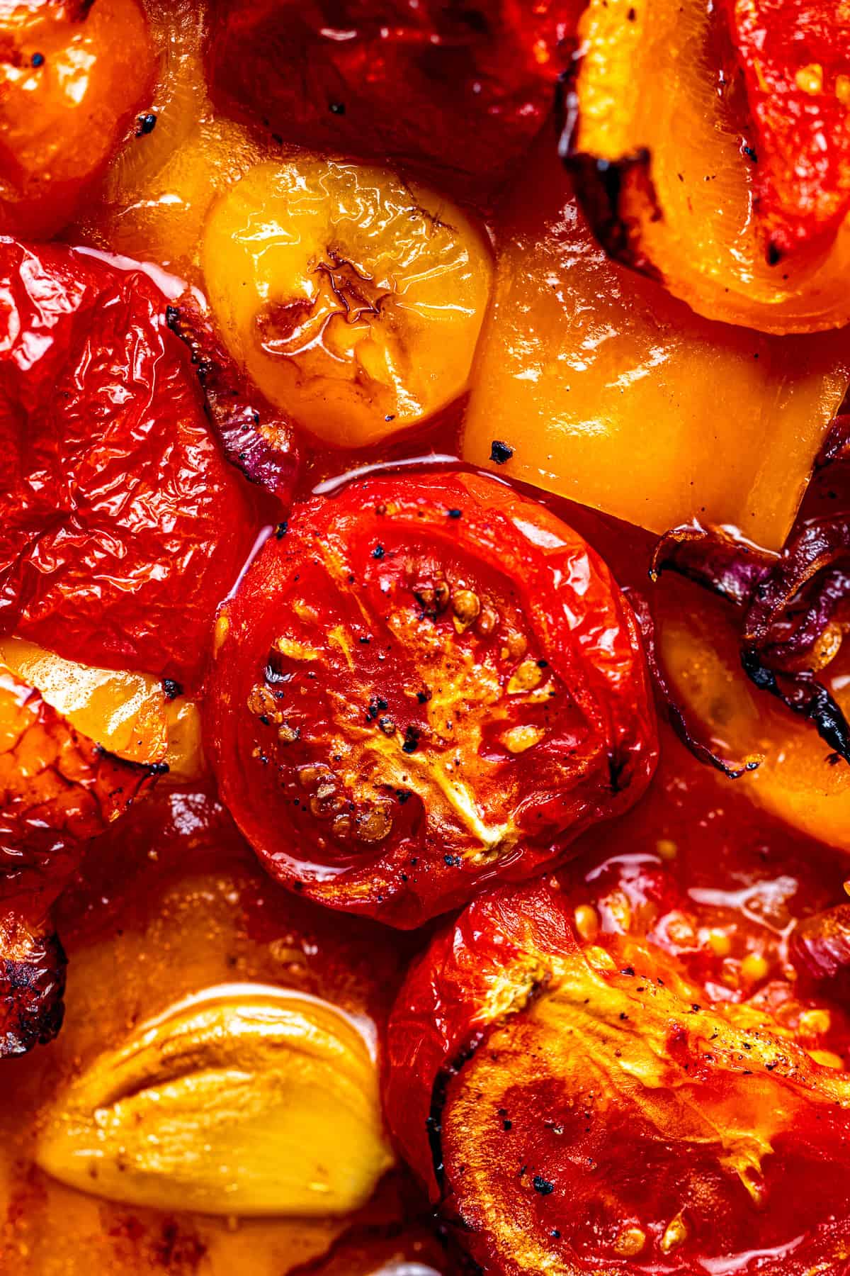 Close up of roasted tomatoes with onions and garlic for soup.