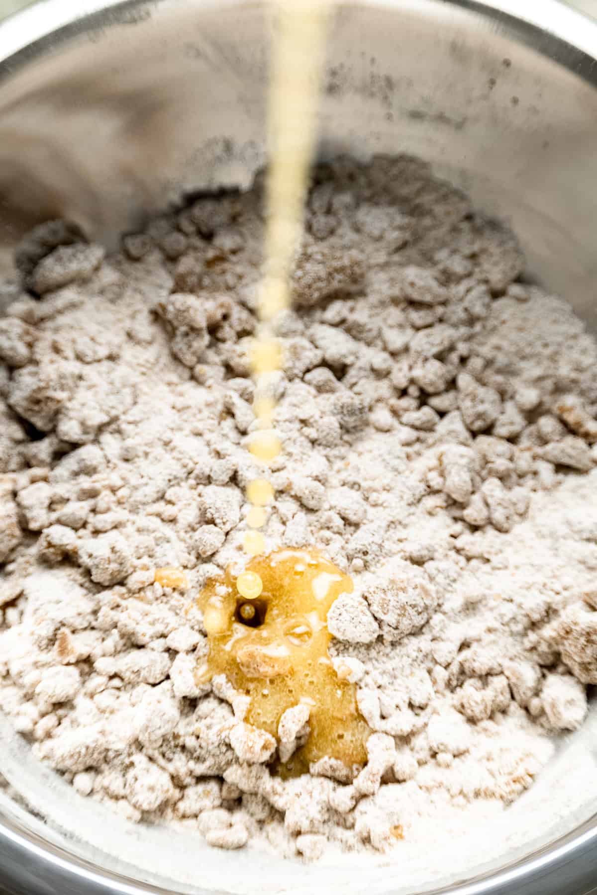 Melted butter being added to crumble topping.
