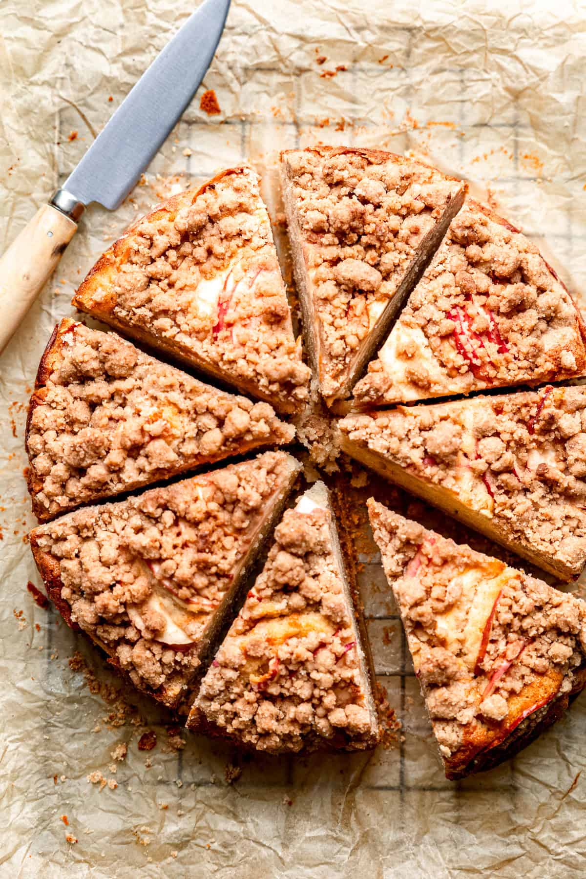 Apple crumble cake on a piece of baking paper.