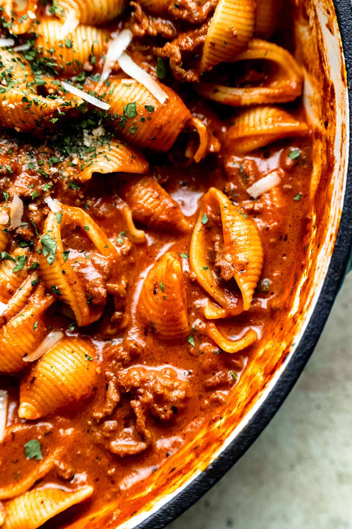 Close up of creamy bolognese and shells pasta.