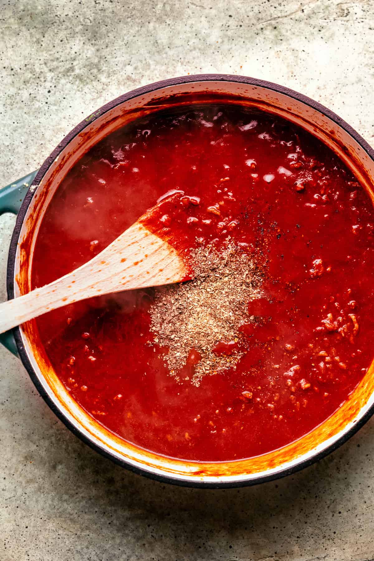 Stock and spices added to the pot for seasoning the bolognese sauce.