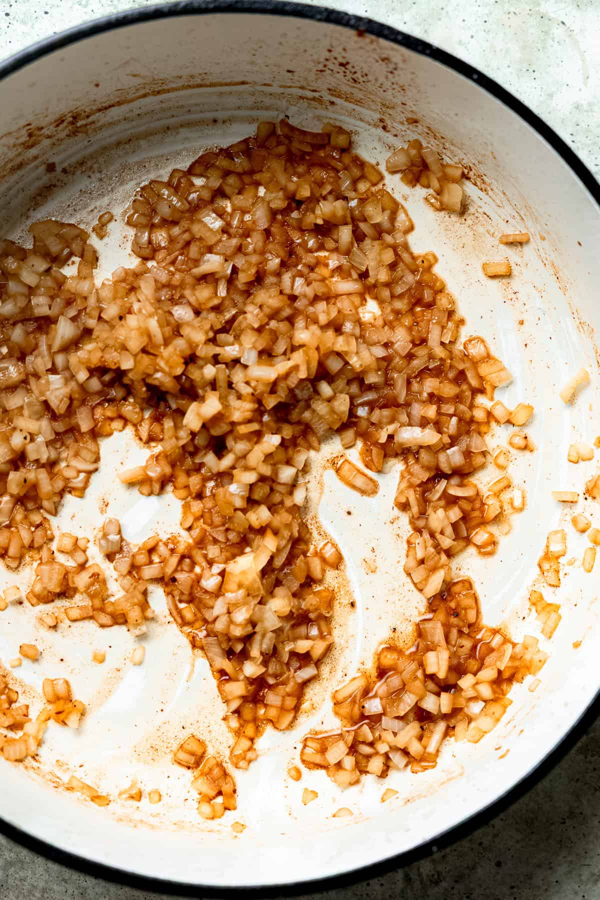 Onions and garlic being cooked until soft and fragrant.