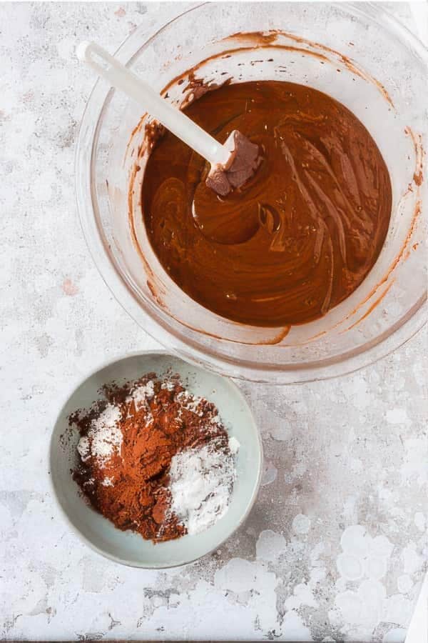 Flour being added to chocolate biscuit dough.